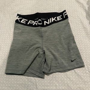 Grey Nike Pros, barely worn but can fit from a med-large.